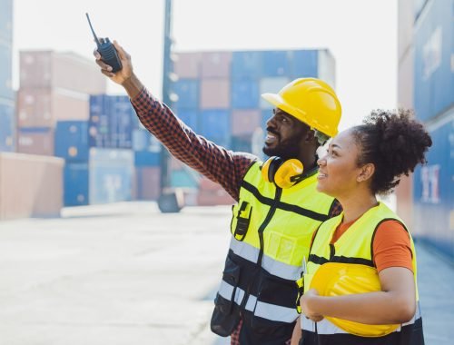 African worker people teamwork happy working together in port cargo shipping industry loading container yard